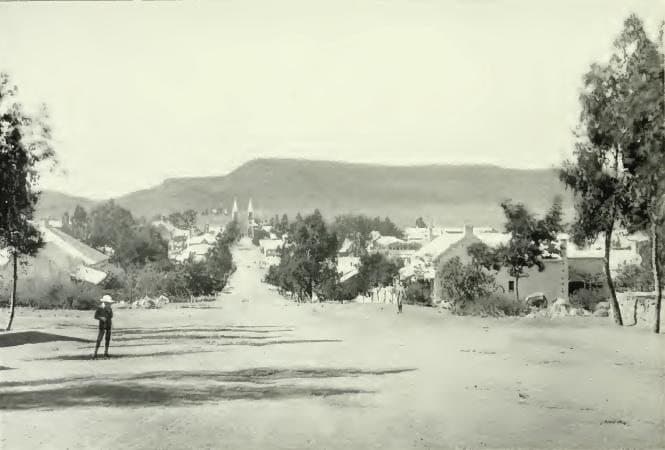 The Church Street (Kerkstraat) in Bloemfontein with the 'Tweetoringkerk' (Church with the two towers) on the end of the road. Naval Hill in the background. (photo from the South - 