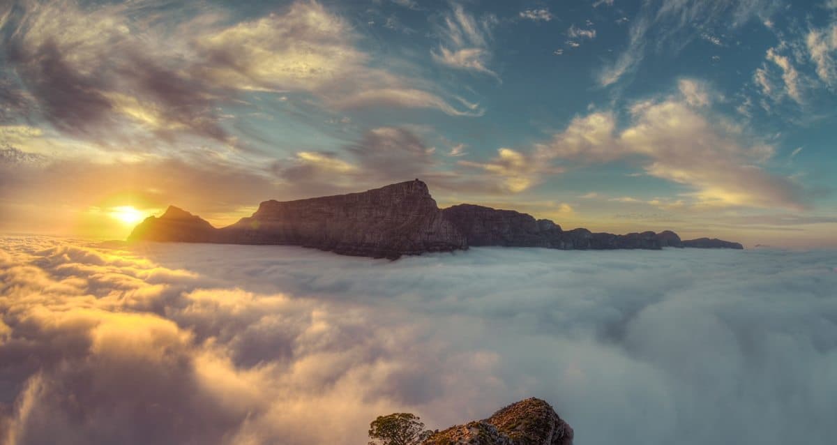 Sunrise from Lionshead above the clouds overlooking Table Moutain